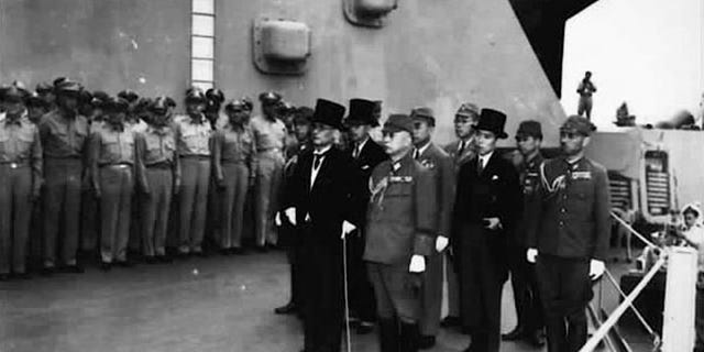 Japan's delegation gather to sign the formal surrender document on the U.S. Navy battleship USS Missouri in Tokyo Bay in a September 2, 1945 file photo.