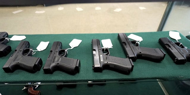 A selection of Glock pistols are seen for sale.
