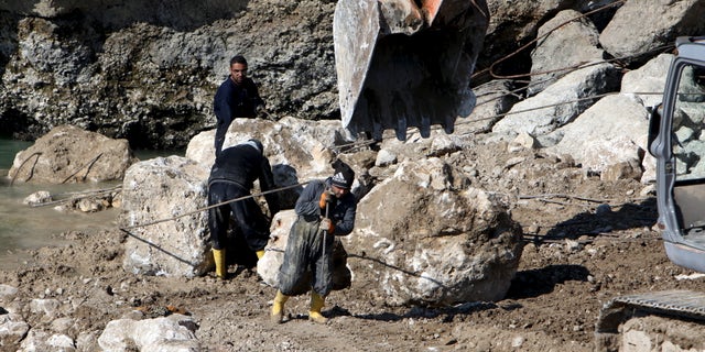 Feb. 3, 2016: Employees work at strengthening the Mosul Dam in northern Iraq. (Reuters)