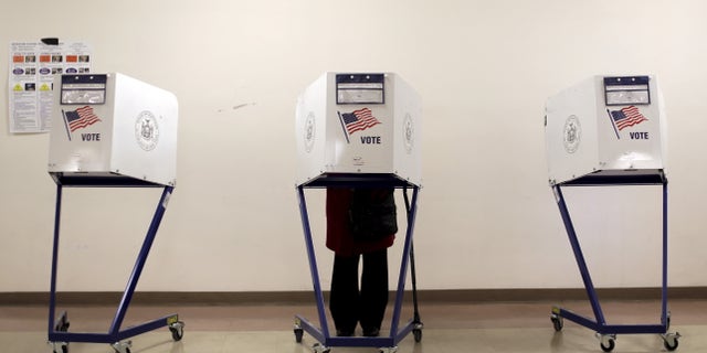 FILE - A voter is seen at a polling station in the Manhattan borough of New York City, April 19, 2016.