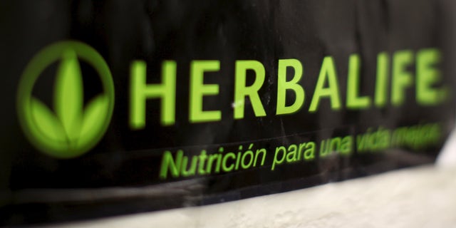 An Herbalife logo is shown on a poster at a clinic in the Mission District in San Francisco, California April 29, 2013.   REUTERS/Robert Galbraith/File Photo          GLOBAL BUSINESS WEEK AHEAD PACKAGE - SEARCH 'BUSINESS WEEK AHEAD MAY 2'  FOR ALL IMAGES - RTX2CDI4