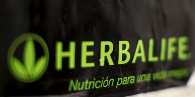 An Herbalife logo is shown on a poster at a clinic in the Mission District in San Francisco, California April 29, 2013. REUTERS/Robert Galbraith/File Photo GLOBAL BUSINESS WEEK AHEAD PACKAGE - SEARCH 'BUSINESS WEEK AHEAD MAY 2' FOR ALL IMAGES - RTX2CDI4