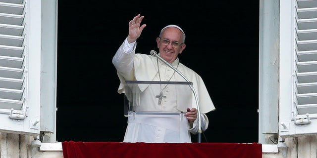 Pope Francis, the current leader of the Roman Catholic Church, waves to a crowd at Saint Peter's Square.