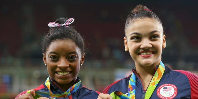 Silver medalist Laurie Hernandez (USA) of USA (R) and bronze medalist Simone Biles (USA) of USA (L) pose with their medals.