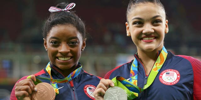 Silver medalist Laurie Hernandez (USA) of USA (R) and bronze medalist Simone Biles (USA) of USA (L) pose with their medals.