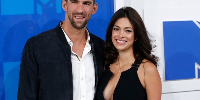 Olympic swimmer Michael Phelps and fiancee Nicole Johnson arrive at the 2016 MTV Video Music Awards in New York, U.S., August 28, 2016.