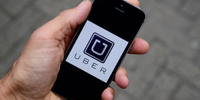 A photo illustration shows the Uber app logo displayed on a mobile telephone, as it is held up for a posed photograph in central London, Britain October 28, 2016. REUTERS/Toby Melville/Illustration - RTX2QUZ9