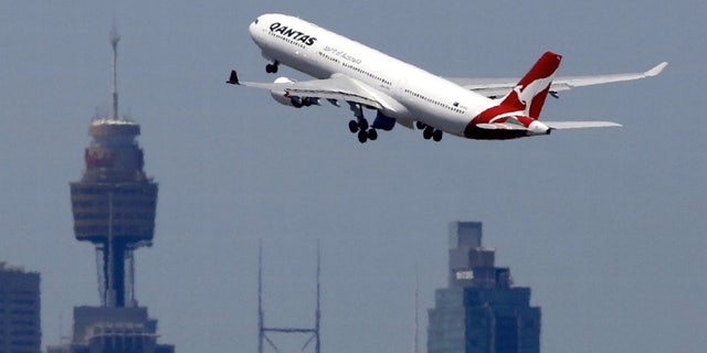A Qantas Airways Airbus A330-300 jet takes off from Sydney International Airport over the city skyline, Dec. 18, 2015. (REUTERS/Jason Reed/File photo)