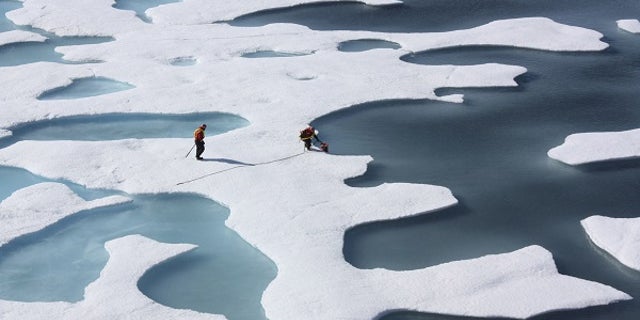 The crew of the U.S. Coast Guard Cutter Healy, in the midst of their ICESCAPE mission, retrieves supplies in the Arctic Ocean in this July 12, 2011 NASA handout photo. Kathryn Hansen/NASA via REUTERS/File Photo ATTENTION EDITORS - THIS IMAGE WAS PROVIDED BY A THIRD PARTY. EDITORIAL USE ONLY. - RTX2RRXI