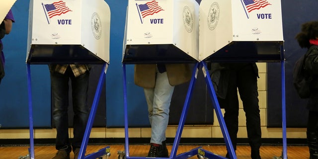 FILE -- Americans vote at a polling station on election day in Harlem, New York, U.S., November 8, 2016.
