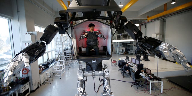 An employee controls the arms of a manned biped walking robot "METHOD-2" during a demonstration in Gunpo, South Korea, December 27, 2016. (REUTERS/Kim Hong-Ji)