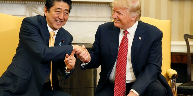 Japanese Prime Minister Shinzo Abe shakes hands with U.S. President Donald Trump during their meeting in the Oval Office at the White House in Washington, Feb. 10, 2017.