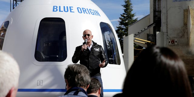 FILE -- Amazon and Blue Origin founder Jeff Bezos addresses the media about the New Shepard rocket booster and Crew Capsule mockup at the 33rd Space Symposium in Colorado Springs, Colorado, April 5, 2017.