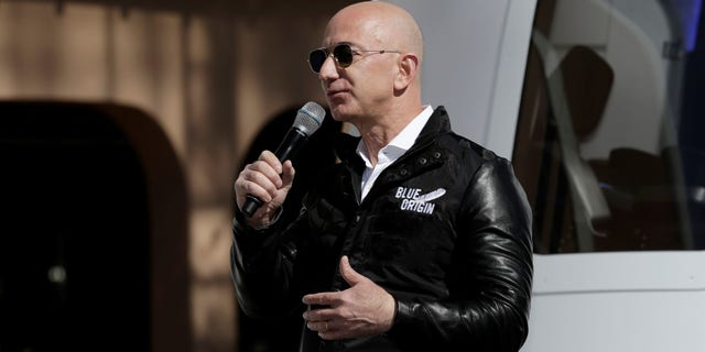 FILE -- Amazon and Blue Origin founder Jeff Bezos addresses the media about the New Shepard rocket booster and Crew Capsule mockup at the 33rd Space Symposium in Colorado Springs, Colorado, April 5, 2017.