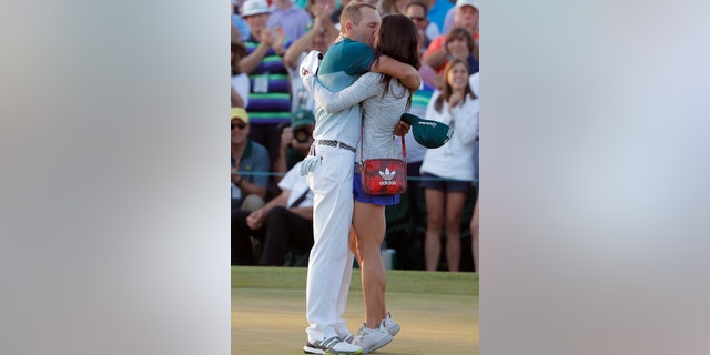 Sergio Garcia of Spain kisses his fiance Angela Akins after he won the 2017 Masters golf tournament.