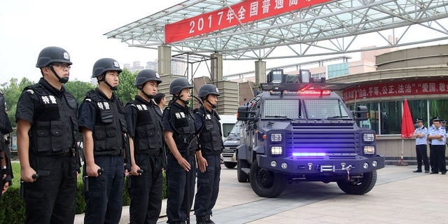 Special force police officers stand guard outside a high school, on the first day of China's national college entrance exam known as "gaokao", in Binzhou, Shandong province, China June 7, 2017.
