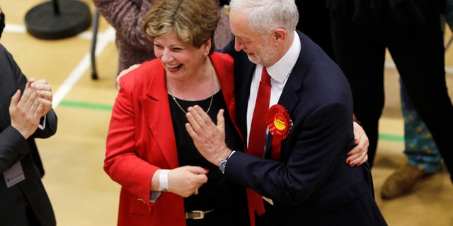 Jeremy Corbyn, leader of Britain's Labour Party tries to exchange a high five with Shadow Foreign Secretary Emily Thornberry at Britain's general election counting centre in Islington, London, June 9, 2017. REUTERS/Darren Staples - RTX39RN5