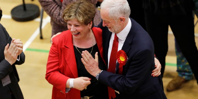 Jeremy Corbyn, leader of Britain's Labour Party tries to exchange a high five with Shadow Foreign Secretary Emily Thornberry at Britain's general election counting centre in Islington, London, June 9, 2017. REUTERS/Darren Staples - RTX39RN5