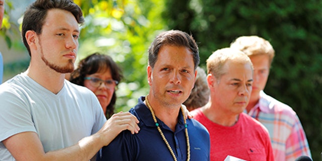 Don Damond is comforted by his son Zach Damond as he speaks to the media about his fiance, Justine Damond who was fatally shot by Minneapolis police in Minneapolis, Minnesota, U.S., July 17, 2017.