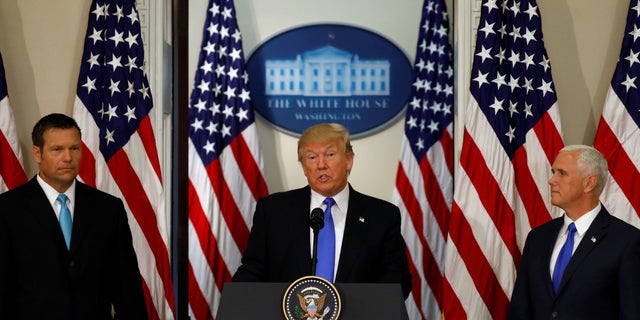 President Donald Trump speaks at the first meeting of the Presidential Advisory Commission on Election Integrity co-chaired by Kansas Secretary of State Kris Kobach (L) and Vice President Mike Pence (R).