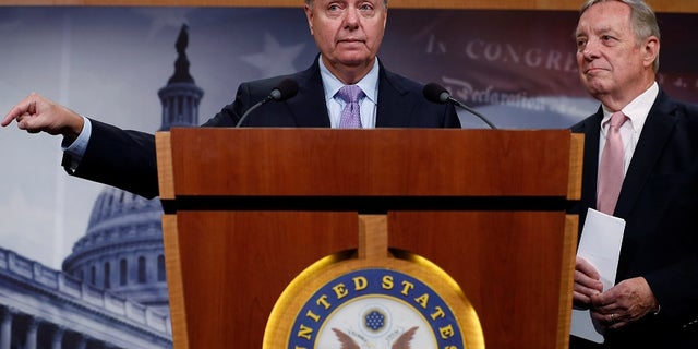 U.S. Senator Lindsey Graham (R-SC), flanked by Senator Dick Durbin (D-IL) (R), talks about possible legislation for so-called "dreamer" immigrant children as well as the health of his friend Senator John McCain (R-AZ), during a news conference at the U.S. Capitol in Washington, U.S. July 20, 2017. REUTERS/Jonathan Ernst - RTX3CA1F