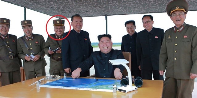 Kim Jong Sik, indicated in picture, stands behind North Korean leader Kim Jong Un, who is inspecting a long and medium-range ballistic rocket.