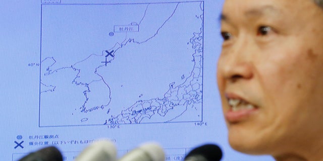 Japan Meteorological Agency's earthquake and tsunami observations division director Toshiyuki Matsumori speaks in front of a screen showing the seismic event that was indicated in North Korea and observed in Japan.