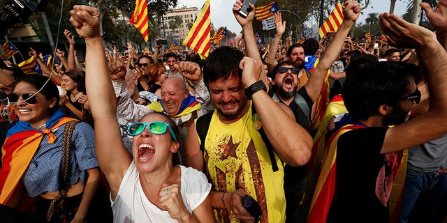 Pro-independence Catalan celebrate outside the Parliament after lawmakers voted to declare the region's independence from Spain.