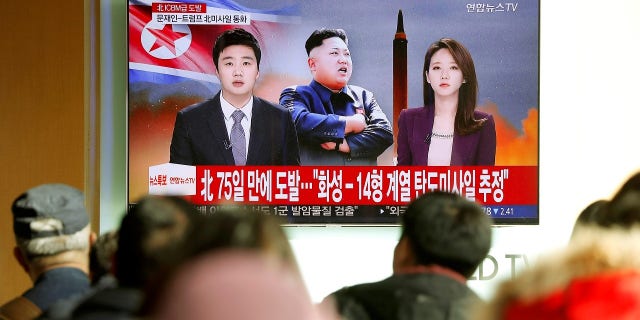 People watch a TV broadcasting a news report on North Korea firing what appeared to be an intercontinental ballistic missile (ICBM) that landed close to Japan, in Seoul, South Korea.