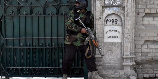 A policeman takes position after gunmen attacked the Bethel Memorial Methodist Church in Quetta, Pakistan.
