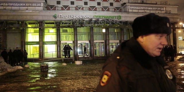 A policeman stands guard near a supermarket after an explosion in St Petersburg, Russia on Wednesday.