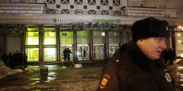A policeman stands guard near a supermarket after an explosion in St Petersburg, Russia on Wednesday.