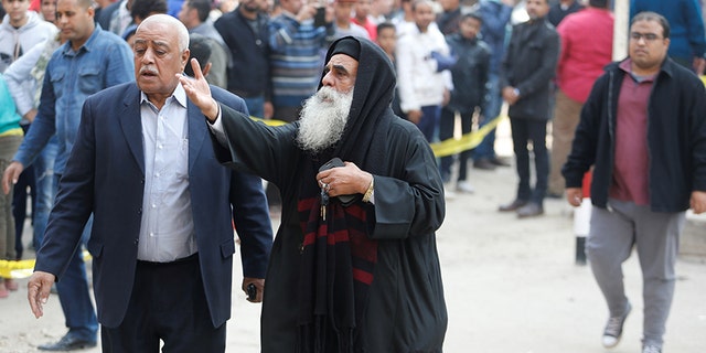 A priest reacts at the site of attack on a church in the Helwan district south of Cairo, Egypt.