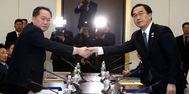 Head of the North Korean delegation, Ri Son Gwon, left, shakes hands with South Korean counterpart Cho Myoung-gyon.