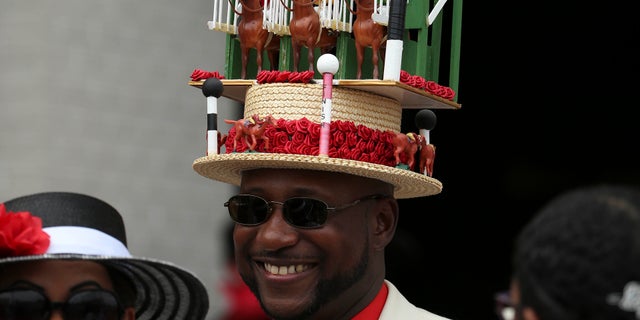 A patron wears a decorated derby hat before the 142nd running of the Kentucky Derby at Churchill Downs.