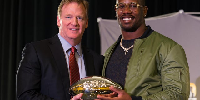 NFL commissioner Roger Goodell and Denver Broncos outside linebacker Von Miller hold the MVP Trophy.