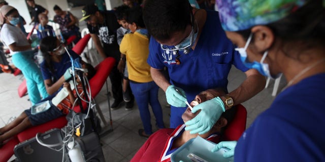Dentists and dentistry students attend to patients in a makeshift clinic set up at the Charismatic Church, after Hurricane Maria hit the island in September.