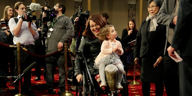 FILE -- Senator Tammy Duckworth (D-IL) carries her daughter Abigail, January 3, 2017.