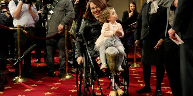 FILE -- Senator Tammy Duckworth (D-IL) carries her daughter Abigail, January 3, 2017.