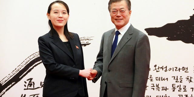 South Korean President Moon Jae-in, right, talks with Kim Yo Jong, the sister of North Korean leader Kim Jong Un.