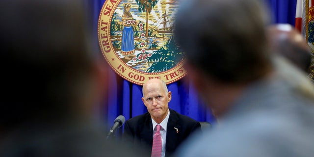Florida Gov. Rick Scott listens during a meeting with law enforcement, mental health, and education officials about how to prevent future tragedies in the wake of the deadly school shooting earlier this month.