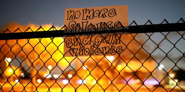 A note is seen on the fence of the Marjory Stoneman Douglas High School following the mass shooting, in Parkland, Florida.
