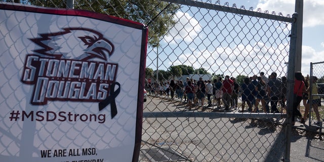 Students and parents arrive for voluntary campus orientation at the Marjory Stoneman Douglas High School, for the coming reopening after the mass shooting on Feb. 14.