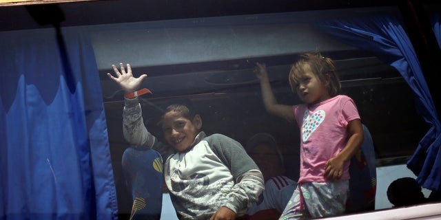 Migrant children from Central America arrive in a caravan at a temporary shelter set up for them by the Roman Catholic church, in Mexico City, April 9, 2018.