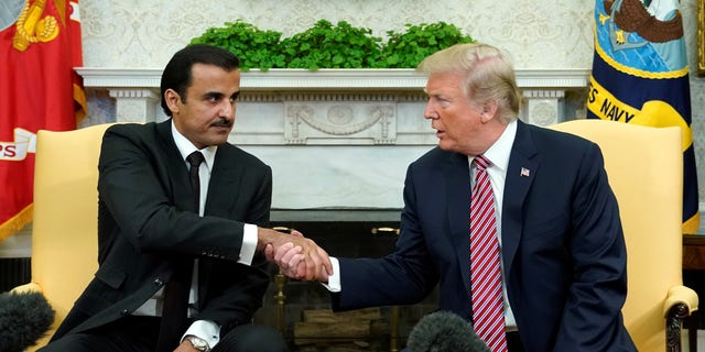 FILE -- President Donald Trump meets Qatar's Emir Sheikh Tamim bin Hamad al-Thani in the Oval Office at the White House in Washington, April 10, 2018.