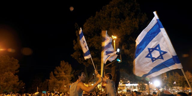 FILE -- Israelis dance with Israeli national flags during celebrations marking Israel's 70th Independence Day in Jerusalem April 18, 2018.