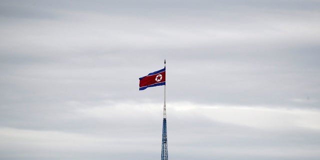 In this April 24, 2018 photo, a North Korean flag flies in the village of Gijungdong.