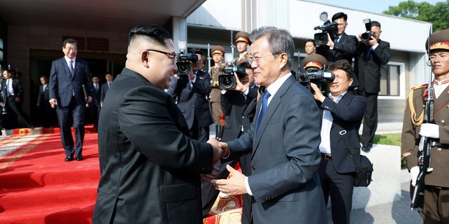In this May 26, 2018 photo, South Korean President Moon Jae-in meets with North Korean leader Kim Jong Un as he leaves after their summit at the truce village of Panmunjom, North Korea.