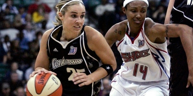 San Antonio Silver Stars guard Becky Hammon drives past Detroit Shock guard Deanna Nolan during the first half of Game 3 of their WNBA basketball finals in Yipsilanti, Mich., Oct. 5, 2008.