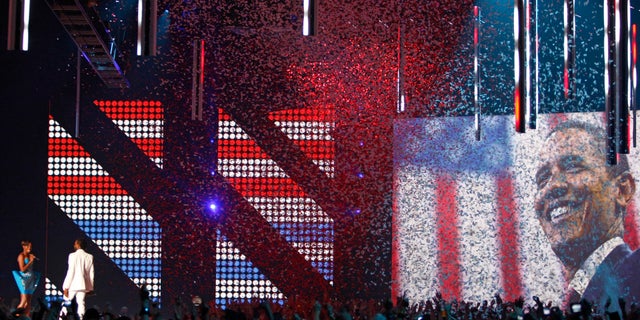 A picture of then-President Barack Obama is projected as Kanye West preforms during the MTV Europe Music Awards in Liverpool in 2008.